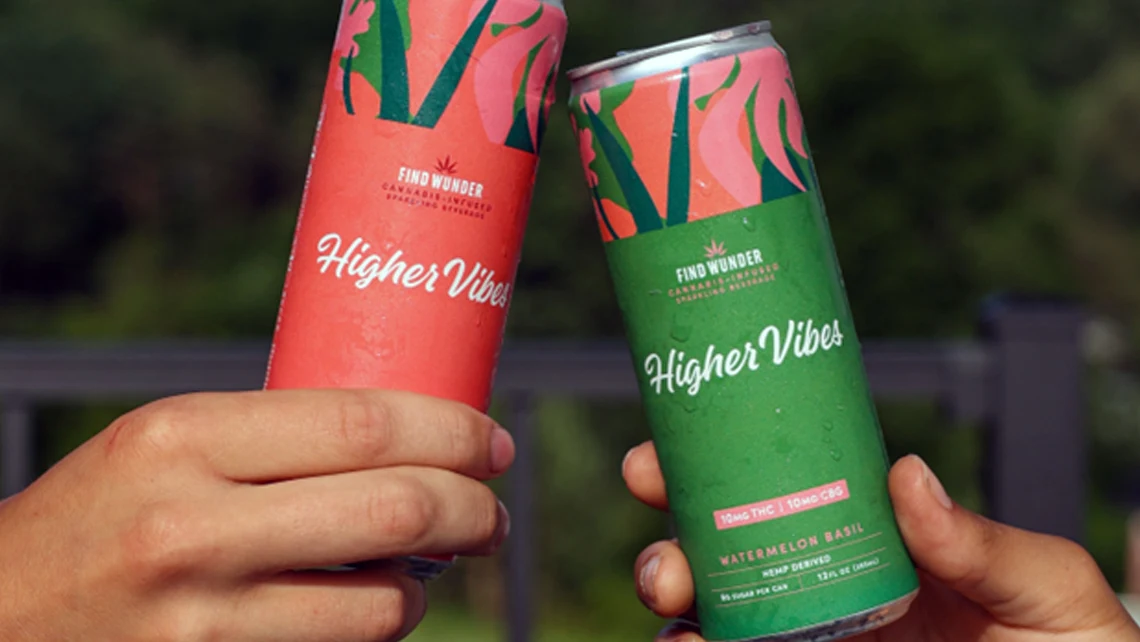 Two hands clinking together two cans of Wunder Higher Vibes THC drinks